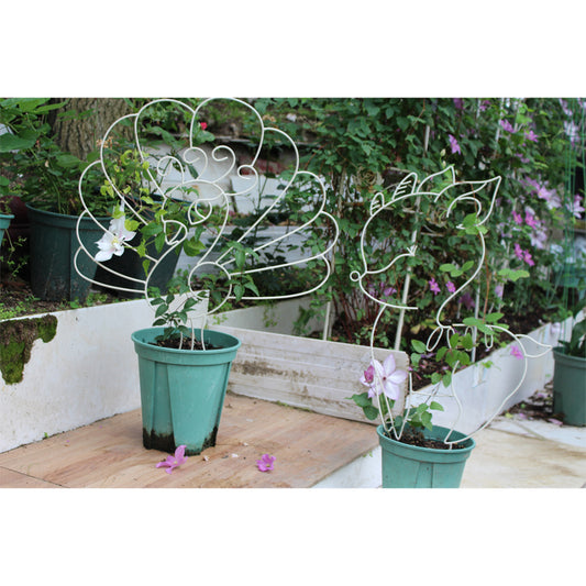 Deer and peacock shaped metal plant stands create an ideal trellis for climbing plants