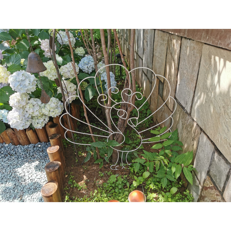 Deer and peacock shaped metal plant stands create an ideal trellis for climbing plants